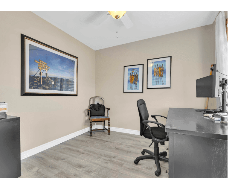 Home office with desk and framed art